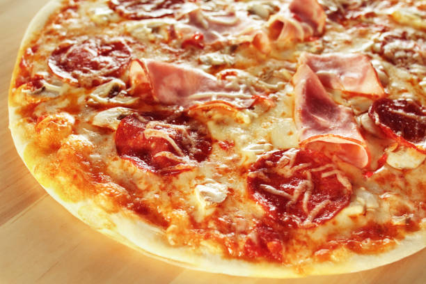 istock Italian Pizza Restaurant Menu - Pizza with pepperoni, ham, mushrooms and cheese 1128515117