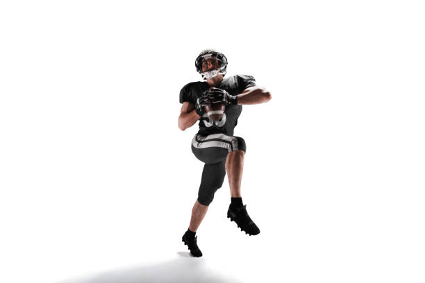 A football player runs back a kickoff.