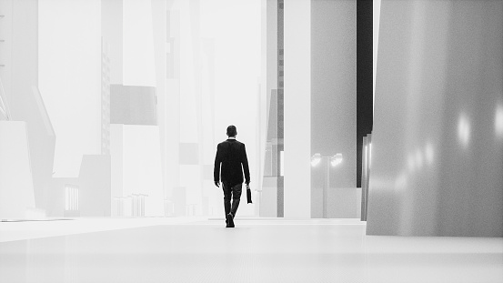 Lone businessman walking in futuristic city