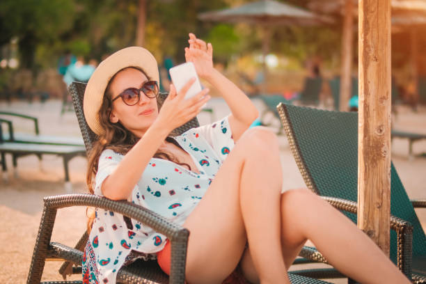 istock Woman in beach chair 1128518885
