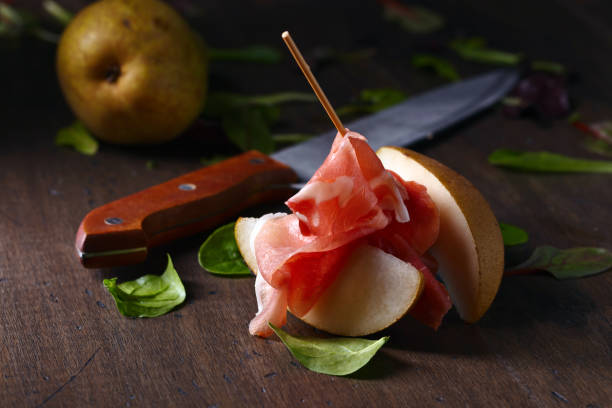 istock prosciutto with pear on a wooden table 1128519059