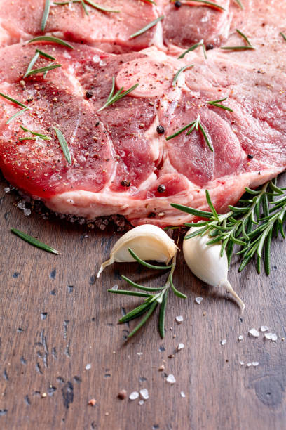 istock Raw pork with rosemary , salt and pepper. 1128519075