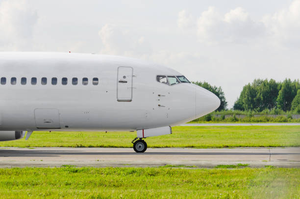 istock Passenger airplane portholes nose cockpit, side view 1128519460