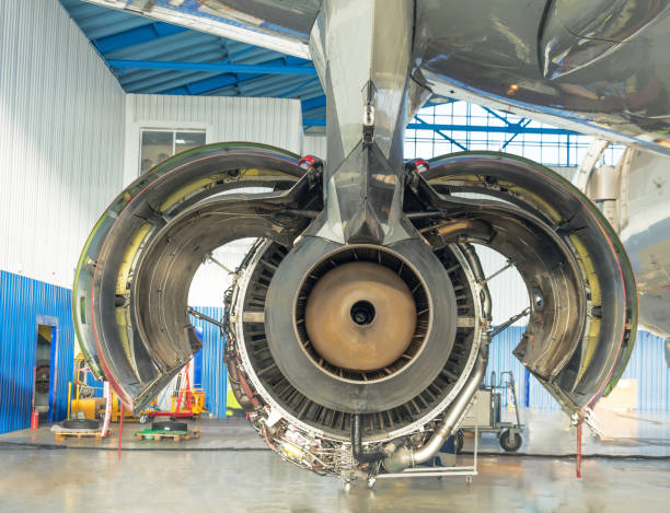 istock Rear view, nozzle. Engine airplanes with open hood flaps on maintenance in a hangar 1128519492