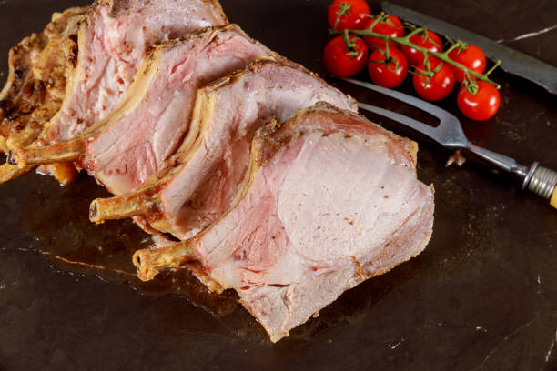 istock Baked pork meat. Slised on cutting board. Top view. 1128522999