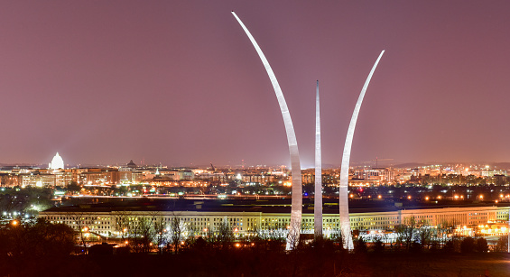The United States Air Force Memorial against the backdrop of the Pentagon and the Capital Building at night. A monument to pilots in Washington.
