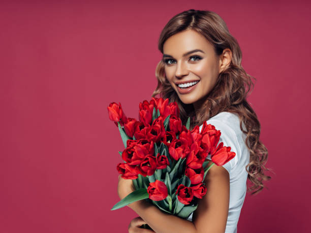 istock Beautiful woman with flowers 1128525847