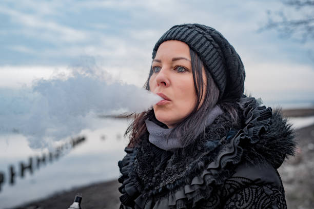 istock Woman vaping outdoors 1128527228