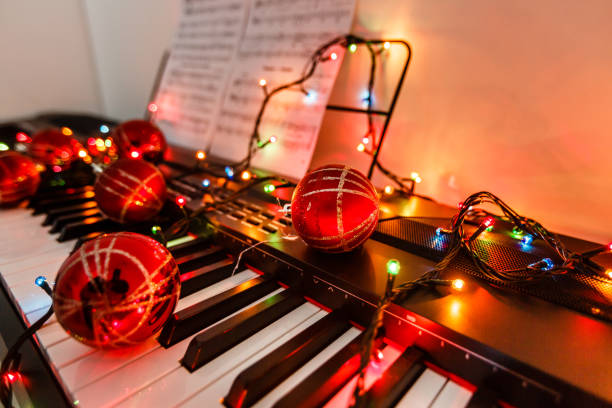 istock Piano keyboard with Christmas decoration, closeup 1128528513