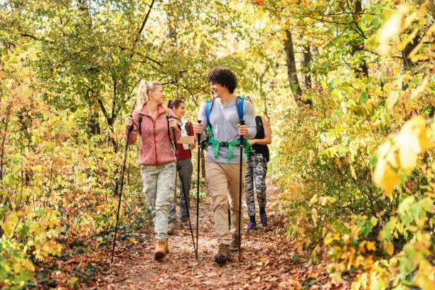 istock Smiling hikers walking through forest at autumn and exploring. Autumn time. 1128529124