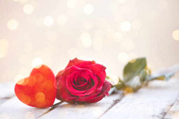 istock Red heart and rose St Valentine background 1128529153