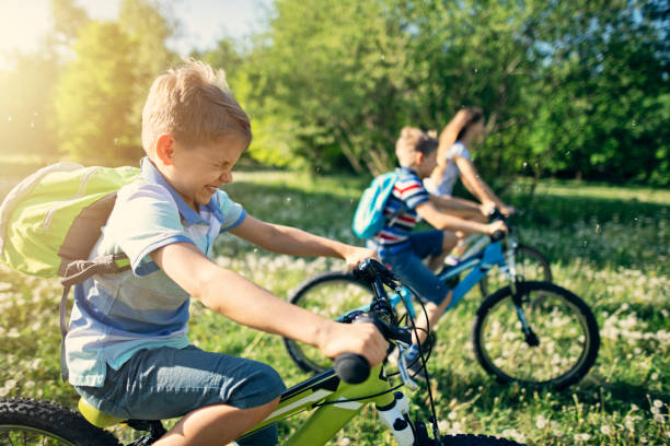 istock Children riding bicycles in dandelion field 1128531893