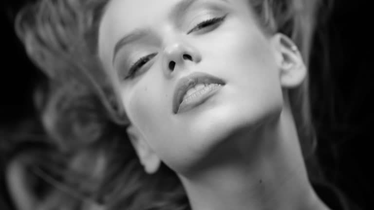 Beautiful woman with natural make-up. Perfect fashion models face. Black & White fashion video. 4K 30fps ProRes 4444