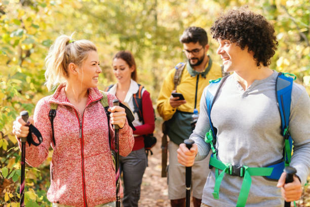 istock Smiling hikers walking through forest at autumn and exploring. Autumn time. 1128532910