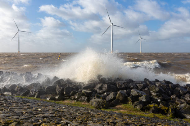 istock Dutch sea with off shore wind turbines and breaking waves 1128534079