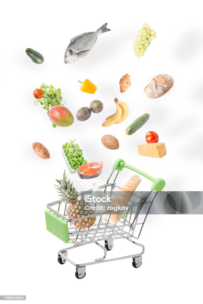 Basket with vegetables on white background. Products falling into the basket.Food package. Levitation Stock Photo