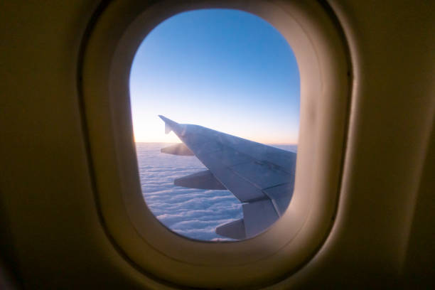 istock Morning light from window of  airplane wing 1128536346
