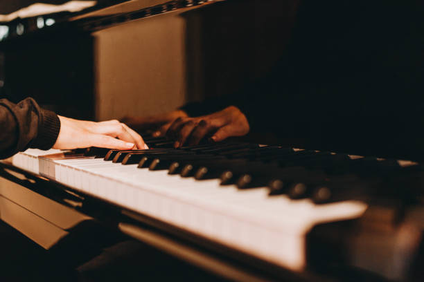 istock Close-up image of a female hands playing piano 1128538034