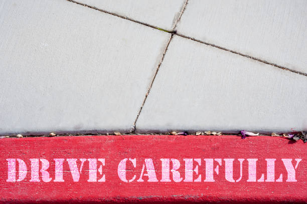 istock Lane with the text Drive carefully on the pavement 1128539159