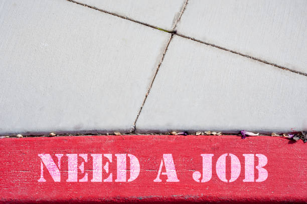 istock Need A Job sign on the parking lot, pavement 1128539220