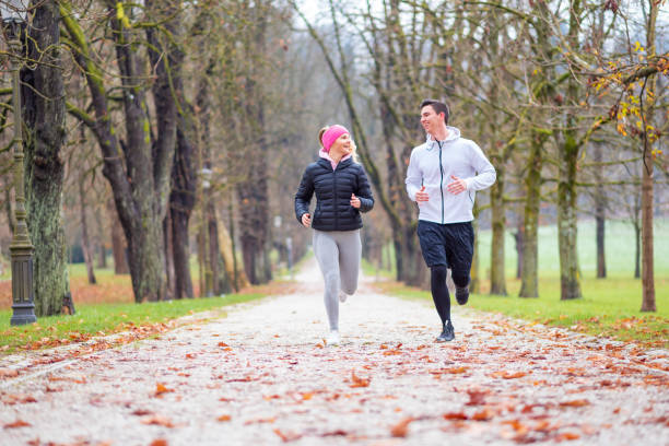 istock Happy couple jogging in park 1128539798