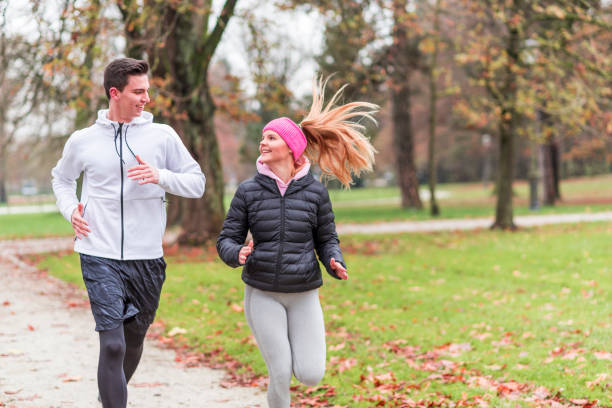 istock Young couple running together 1128542114