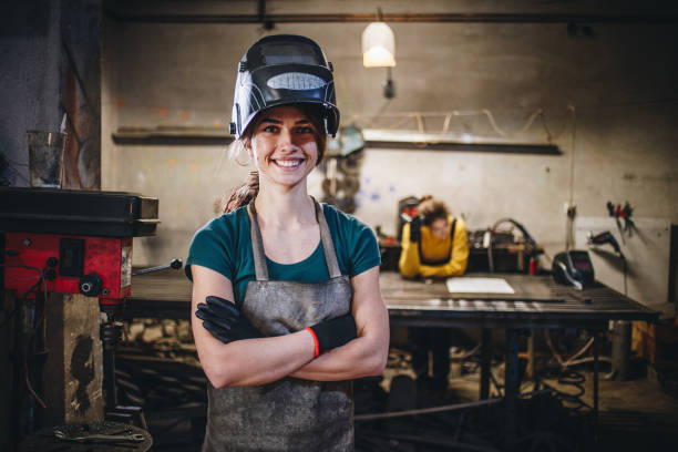 Cheerful girl and her sister in a steel shop stock photo