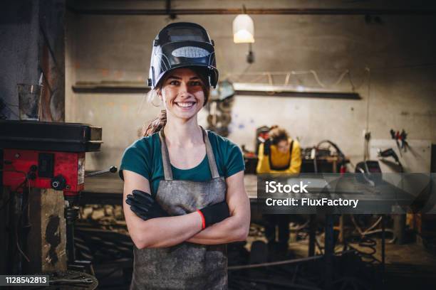 Cheerful Girl And Her Sister In A Steel Shop Stock Photo - Download Image Now - Welder, Portrait, Women