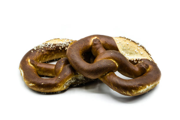 istock Two pretzels with salt isolated on white background 1128543839