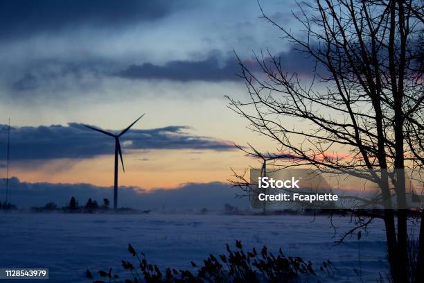 Wind Turbines In The Winter Storm Stock Photo - Download Image Now - American-Style Windmill, Canada, Green Technology