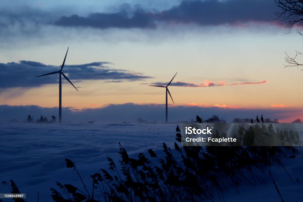 Wind turbines in the winter storm American-Style Windmill Stock Photo