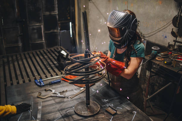 istock Welding girl working in a metal shop 1128544597