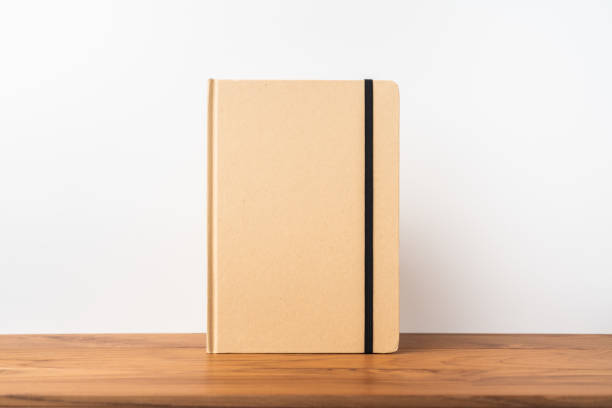 istock Perspective view of kraft notebook on wood floor 1128555444