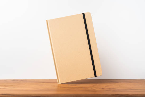 istock Perspective view of kraft notebook on wood floor 1128555463