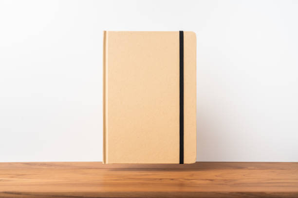 istock Perspective view of kraft notebook on wood floor 1128555485