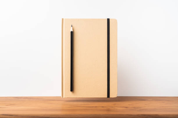 istock Perspective view of kraft notebook on wood floor 1128555496