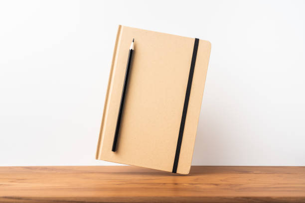 istock Perspective view of kraft notebook on wood floor 1128555509
