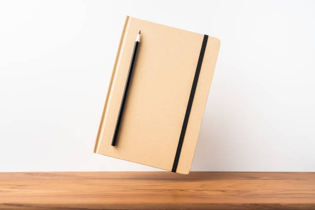istock Perspective view of kraft notebook on wood floor 1128555518