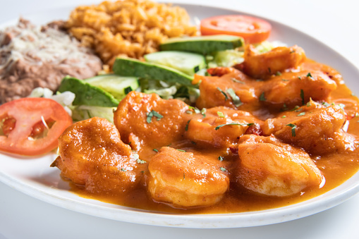 Tiger prawns and shrimp in black plate with ice. Black background. Healthy diet nutrition. Flat view