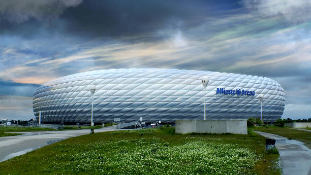 Munich, Bavaria, Germany, April 12, 2025. Red-lit Allianz Arena in Fröttmaning near Munich at night