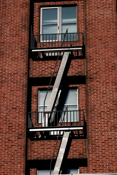 istock Fire Escape staircase set on the wall of a brick building 1128565090