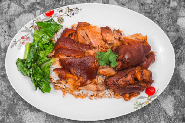 german pork knuckle with rice, vegetable and fruit served with sauce on wooden table. - shank sauerkraut german cuisine pork imagens e fotografias de stock