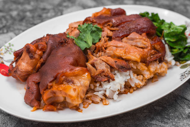 german pork knuckle with rice, vegetable and fruit served with sauce on wooden table. - shank sauerkraut german cuisine pork imagens e fotografias de stock