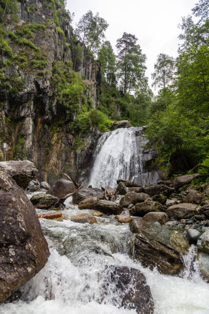 istock A small waterfall in the forest in Altai, Russia 1128572166