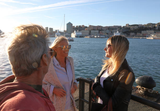 mature parents with daughter talk while waiting for a ferry - men railing passenger ship shipping imagens e fotografias de stock