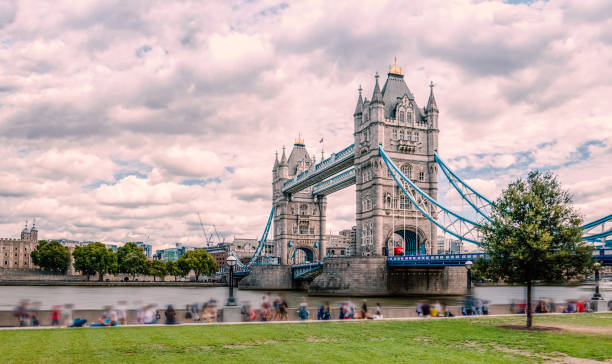 istock Tower bridge with motion blur effect of peoples relaxing 1128575880