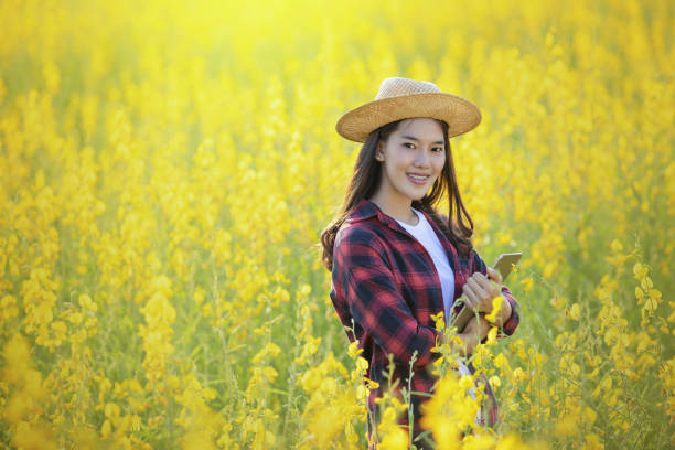 istock Vietnamese girl with yellow flowers. 1128580919