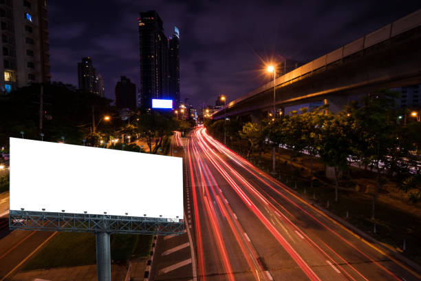 istock empty ginat billboard stand on night cityscape light tail traffic background - can use to display or montage on product or service 1128581055