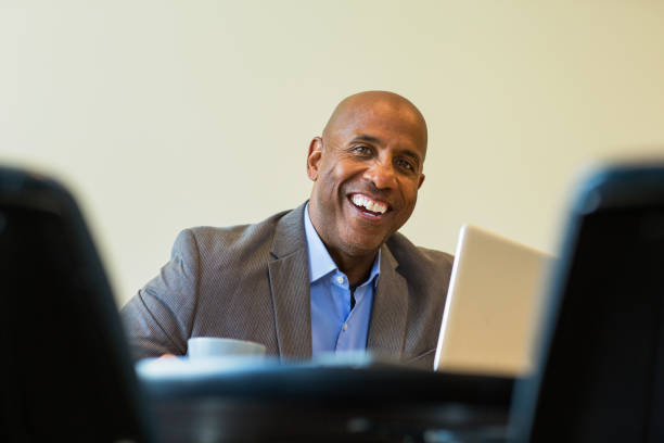 istock Happy mature African American man at work. 1128582623