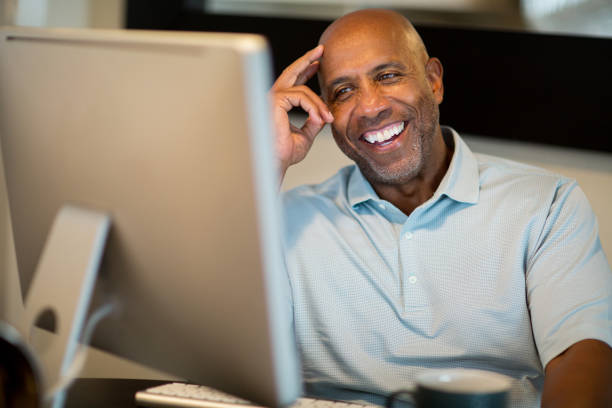 istock Mature African American man working from his home office. 1128582693